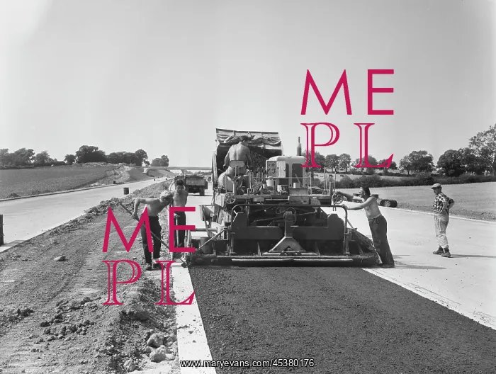 : England. A view of Laing workers operating a paver machine : England. A view of Laing workers operating a paver machine