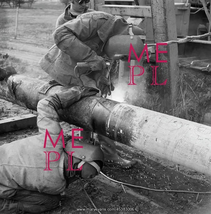 : England. Two welders at work on the Mersey oil pipeline : England. Two welders at work on the Mersey oil pipeline