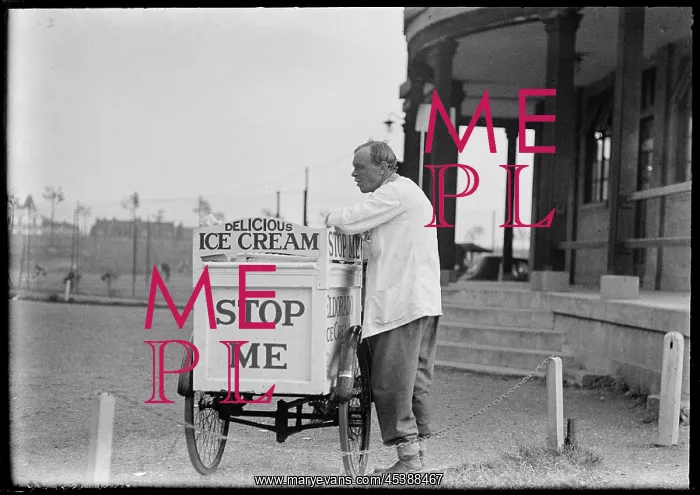: England. An Eldorado ice cream seller standing beside his tricycle cart outside a pavilion : England. An Eldorado ice cream seller standing beside his tricycle cart outside a pavilion