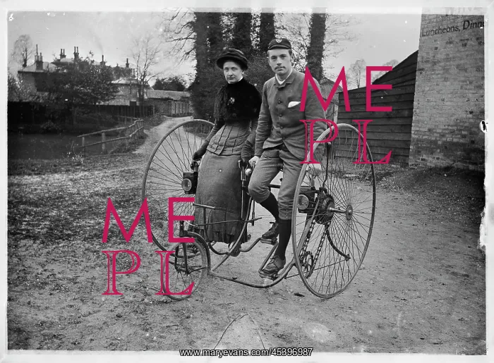 : ENGLAND. Portrait of a man and a woman sitting side by side on a double tricycle_x000D_ : ENGLAND. Portrait of a man and a woman sitting side by side on a double tricycle_x000D_