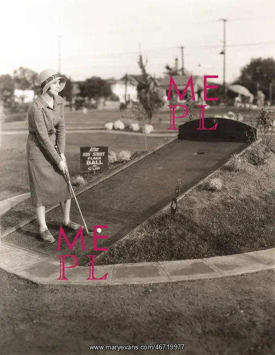 : Enjoying a solo game of miniature golf : Enjoying a solo game of miniature golf