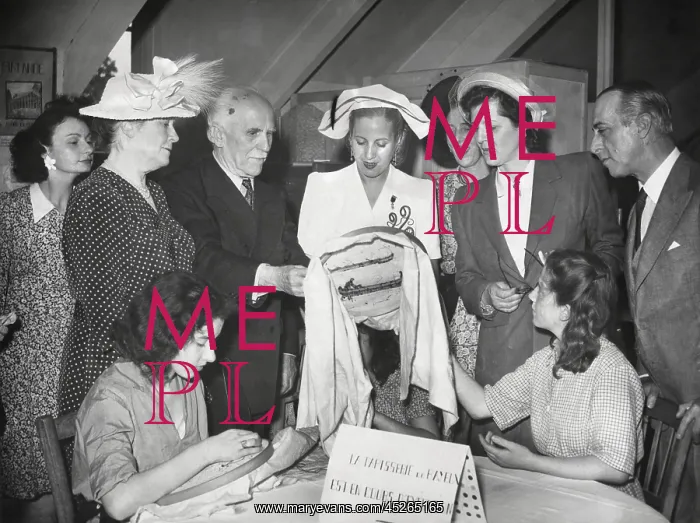 : Eva Peron visiting a sewing workshop where women : Eva Peron visiting a sewing workshop where women