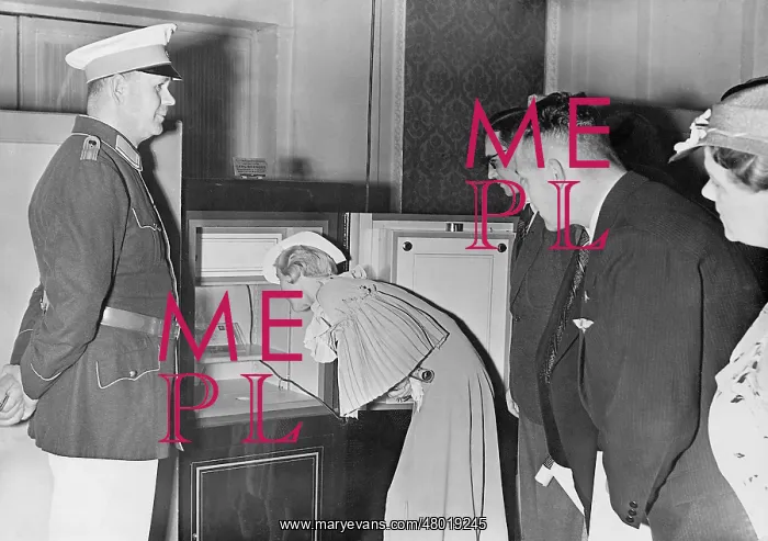 : Exhibition visitor admires a stamp, 1937 : Exhibition visitor admires a stamp, 1937