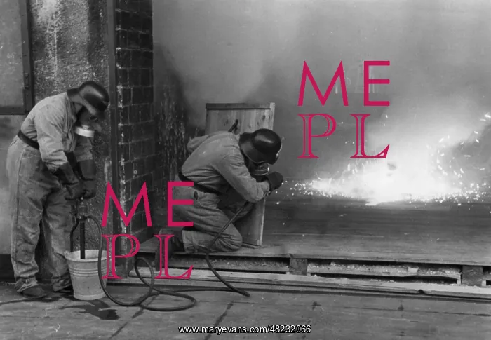 : Extinguishing a fire bomb, 1941 : Extinguishing a fire bomb, 1941