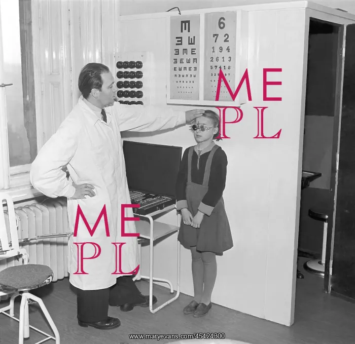  : Eye exam. Czechoslovakia - Prague 1950. Doctor examines girlss eye sight