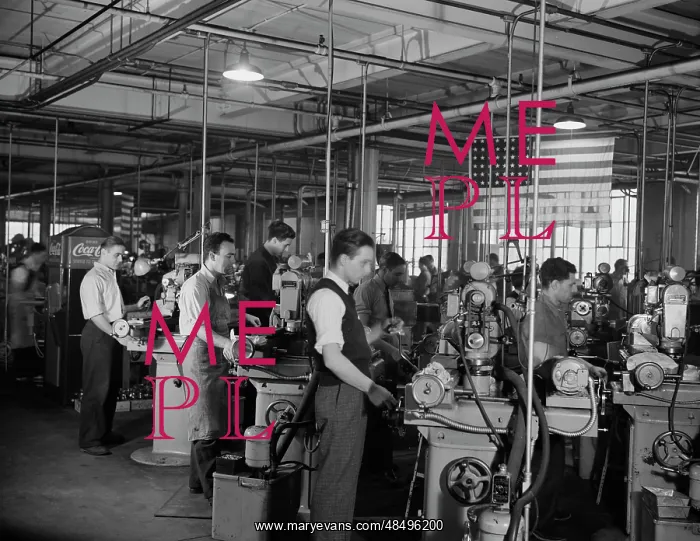  : Factory workers grinding small parts for machine