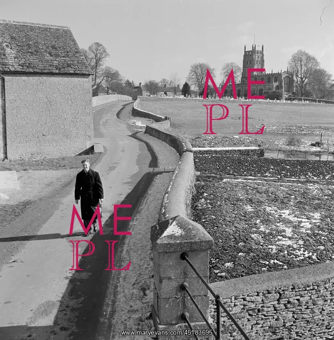 : Fairford. A young man walks along Mill Lane in Fairford towards Mill Bridge, : Fairford. A young man walks along Mill Lane in Fairford towards Mill Bridge,