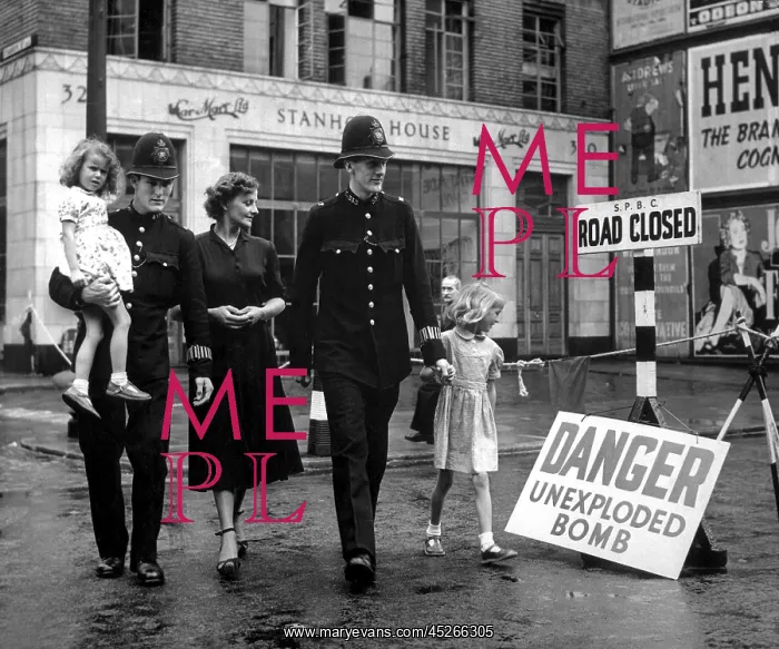 : A family is escorted away from the site of an : A family is escorted away from the site of an