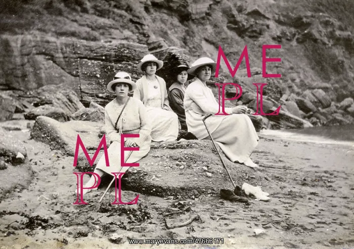 : Family group sitting on a beach at the seaside : Family group sitting on a beach at the seaside