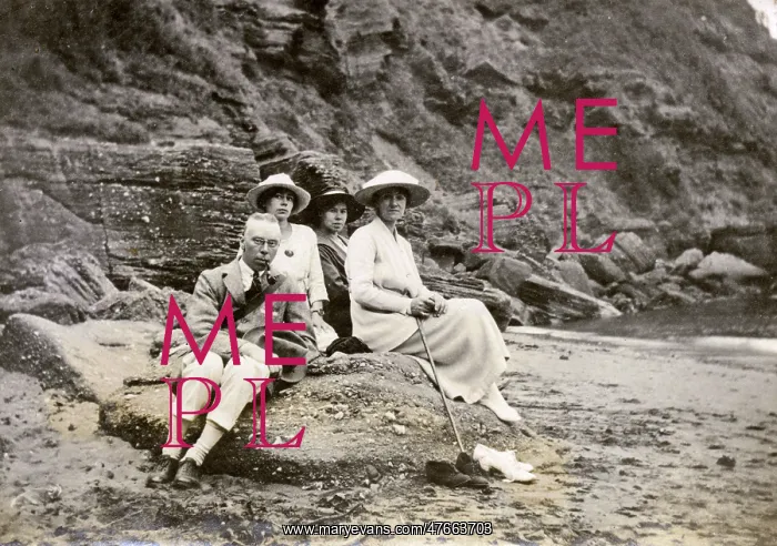 : Family group sitting on a beach at the seaside : Family group sitting on a beach at the seaside