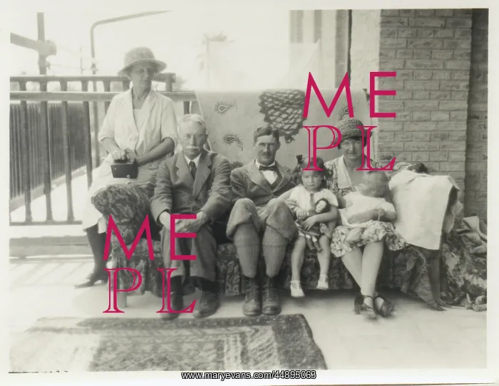 : Family group on a sofa on a verandah : Family group on a sofa on a verandah
