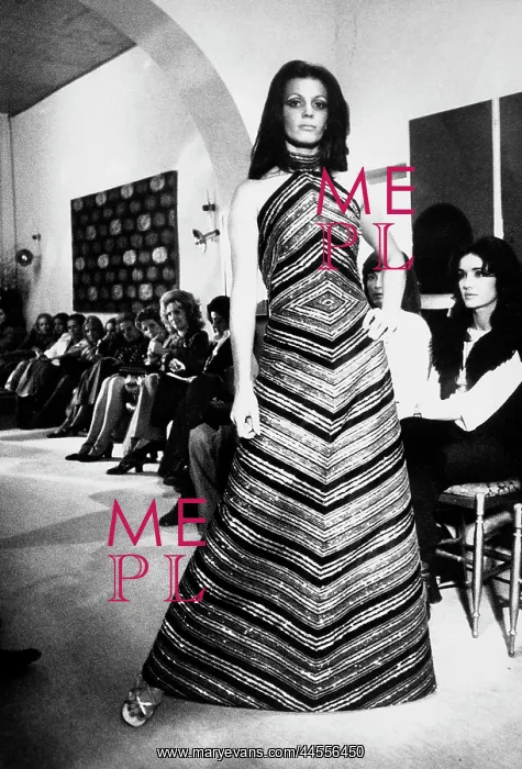 : Fashion show inside an art gallery: a model wearing a long evening gown : Fashion show inside an art gallery: a model wearing a long evening gown