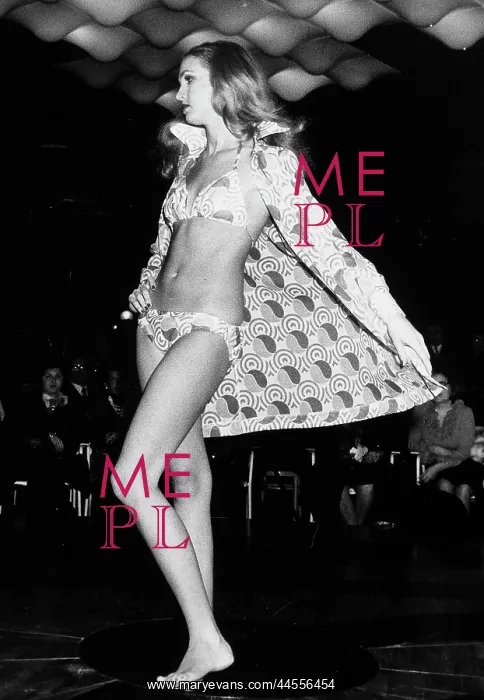 : Fashion show. A model wearing a two-piece bathing suit with a colorful : Fashion show. A model wearing a two-piece bathing suit with a colorful