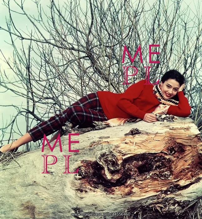 : Fashion. A young woman smiling and lying on a large trunk on the ground : Fashion. A young woman smiling and lying on a large trunk on the ground
