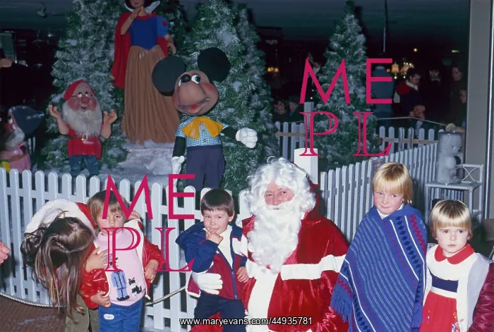 : Father Christmas with children in his grotto : Father Christmas with children in his grotto