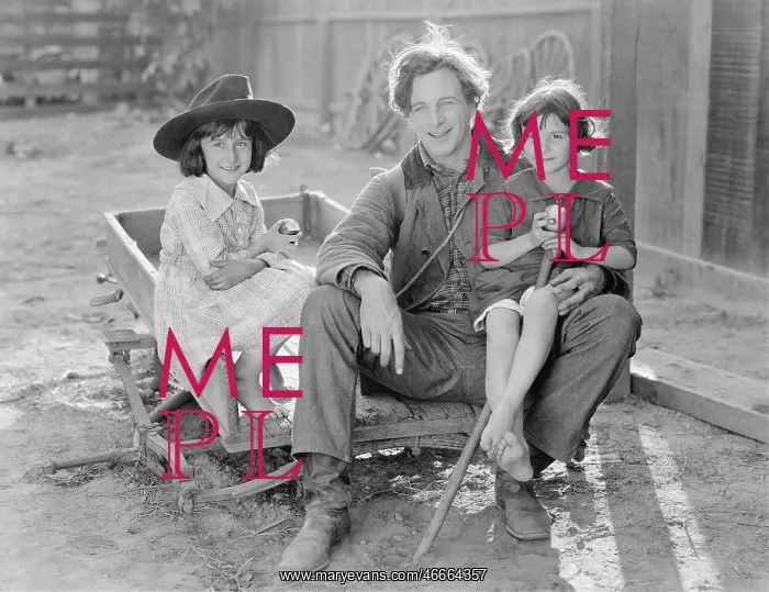 : Father sitting with his two daughters on a small : Father sitting with his two daughters on a small