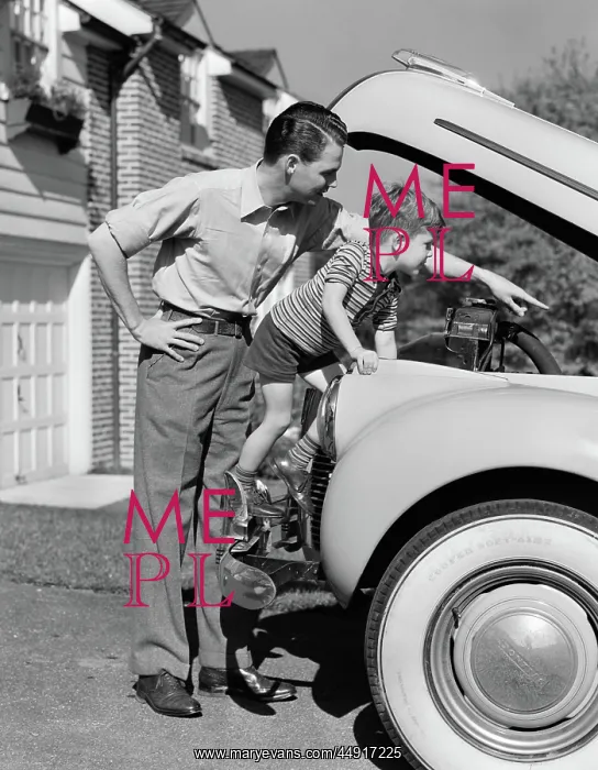 : Father & son checking under hood of car in driveway : Father & son checking under hood of car in driveway