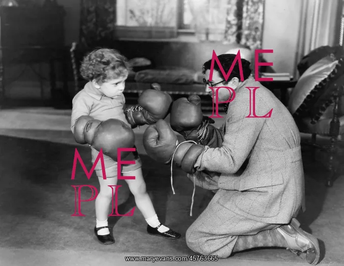  : Father and young son playing with boxing gloves