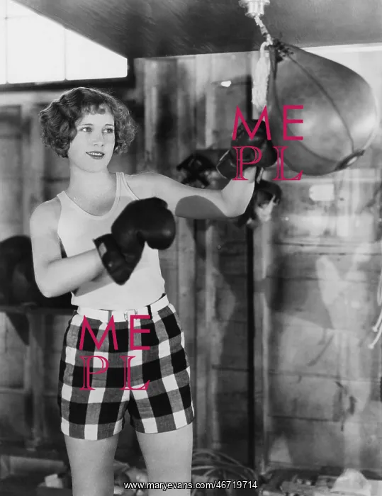 : Female boxer using punching bag : Female boxer using punching bag