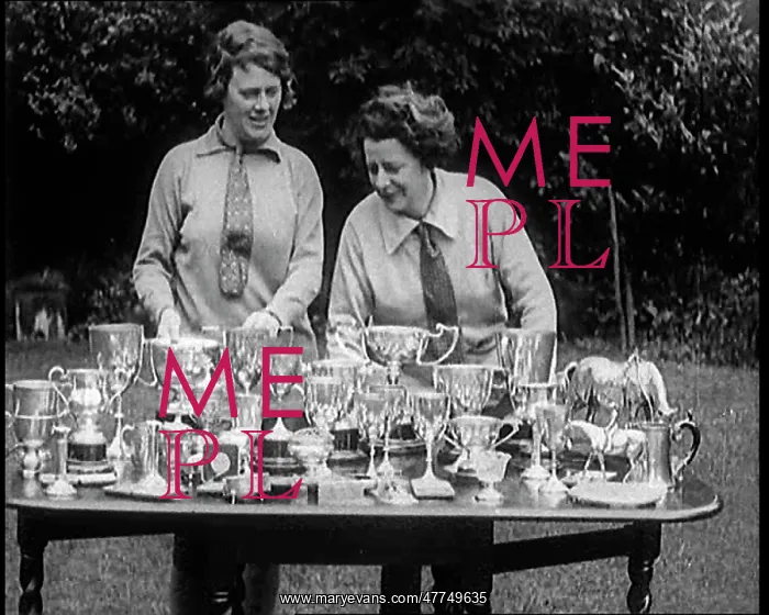 : Two Female Civilians Standing Behind A Table : Two Female Civilians Standing Behind A Table