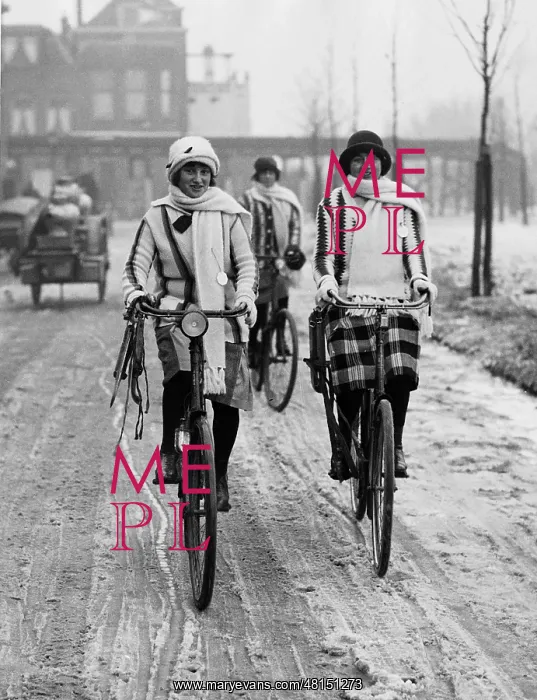 : Two female cyclists in winter, 1925 : Two female cyclists in winter, 1925
