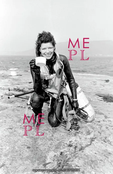 : Female diver returning to dry land : Female diver returning to dry land
