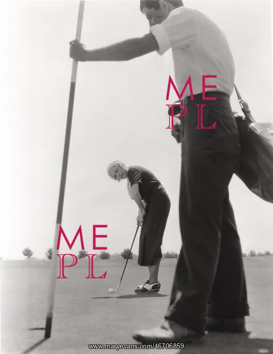 : Female golfer and her caddy : Female golfer and her caddy