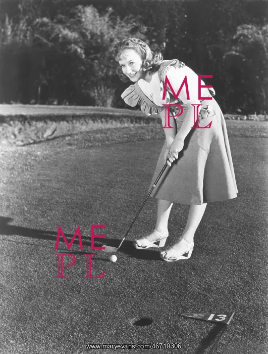 : Female golfer about to take a shot : Female golfer about to take a shot