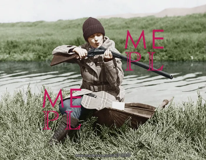 : Female hunter with gun near river : Female hunter with gun near river