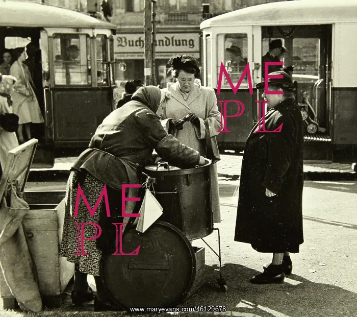 : Female marone seller with two customers : Female marone seller with two customers