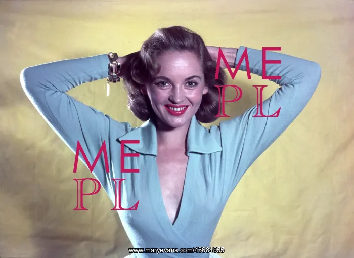 : Female model in a pale blue top : Female model in a pale blue top