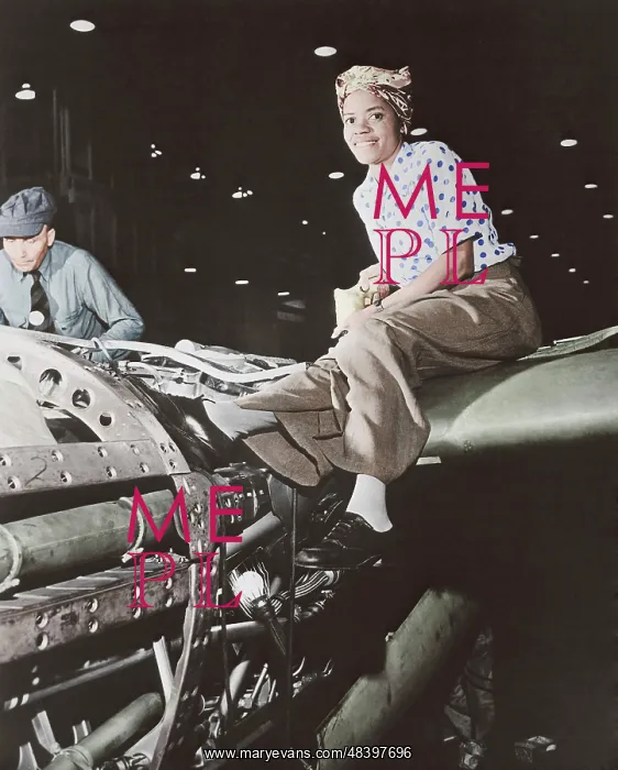 : A female riveter working on the fabrication of an airplane : A female riveter working on the fabrication of an airplane