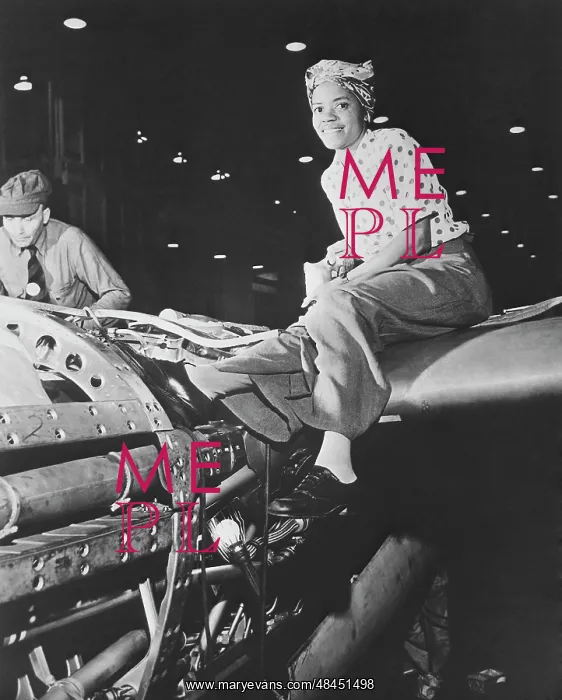 : A female riveter working on the fabrication of an airplane : A female riveter working on the fabrication of an airplane