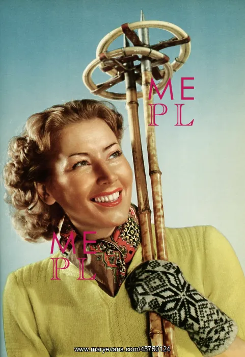 : Female skier with her ski poles : Female skier with her ski poles