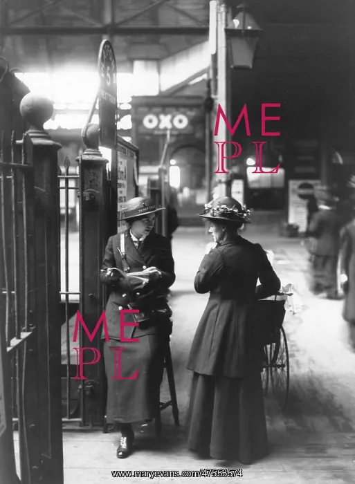 : A female ticket collector at platform five in a London train : A female ticket collector at platform five in a London train