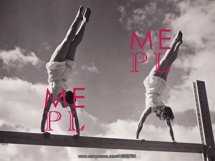: Two females handstands on beam : Two females handstands on beam