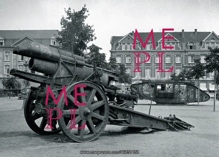 : Field gun and tank in a town square : Field gun and tank in a town square