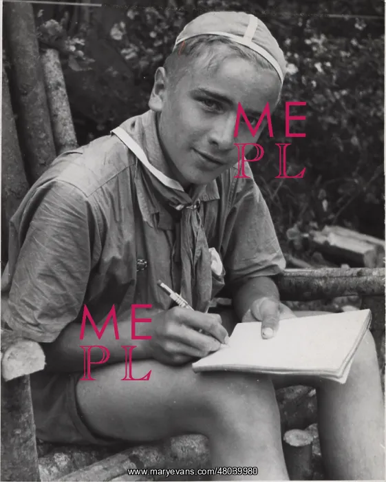 : Finnish boy scout writing in a notebook : Finnish boy scout writing in a notebook