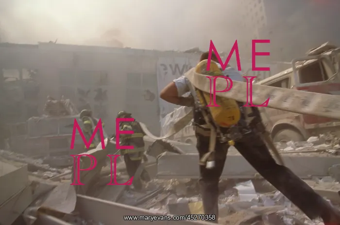 : Fire fighters hauling a hose through rubble on : Fire fighters hauling a hose through rubble on