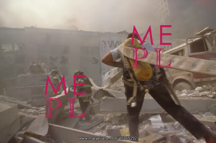 : Fire fighters hauling a hose through rubble on September : Fire fighters hauling a hose through rubble on September
