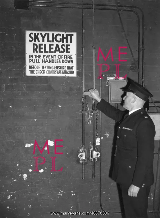 : Fire prevention officer checking skylight release : Fire prevention officer checking skylight release