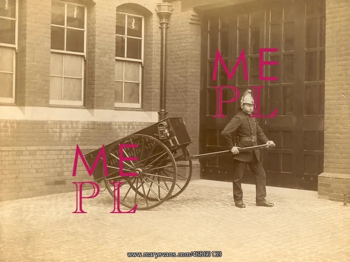  : A firefighter of the London Fire Brigade pulling a cart