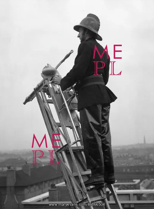 : Firefighter using hook belt at top of ladder : Firefighter using hook belt at top of ladder
