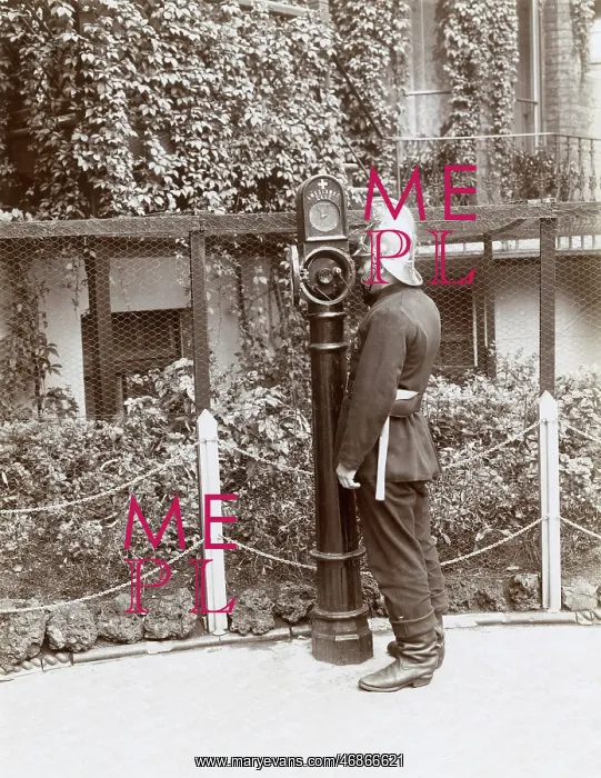 : Firefighter using telephone point in street : Firefighter using telephone point in street