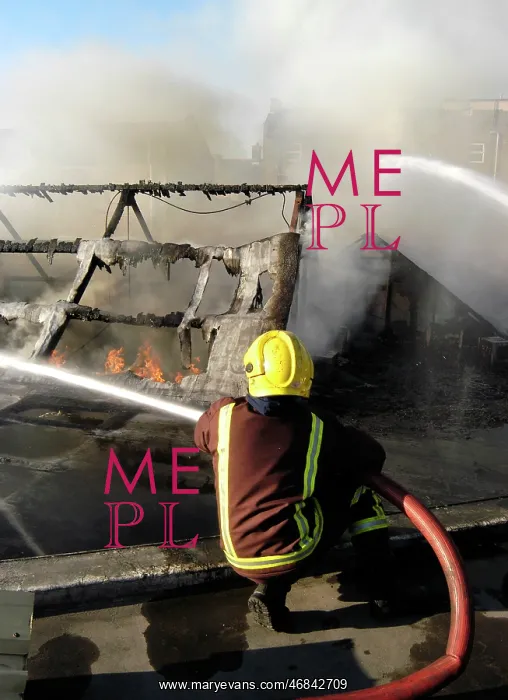 : Firefighter working at scene of fire at New Cross : Firefighter working at scene of fire at New Cross