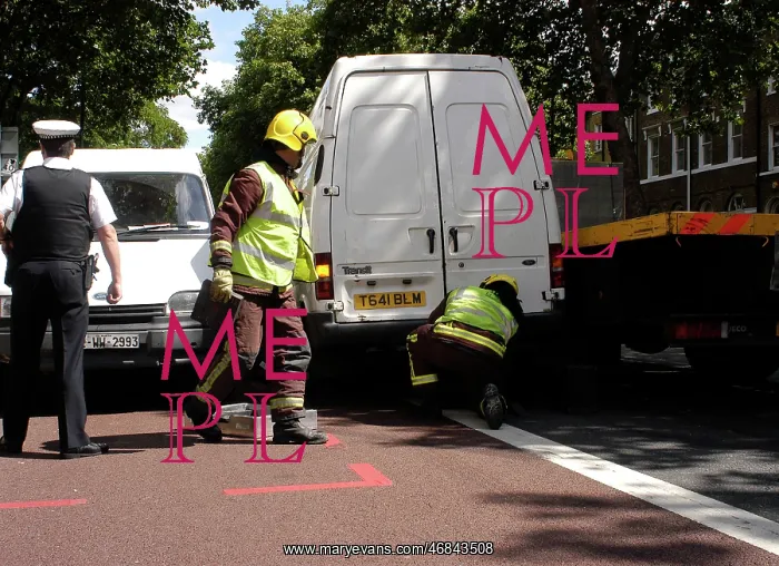 : Firefighters inspecting a broken down Ford transit van : Firefighters inspecting a broken down Ford transit van