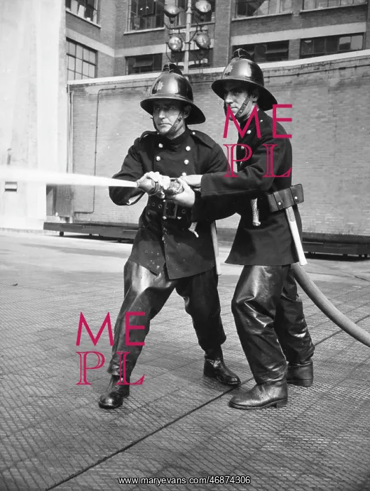 : Firefighters taking part in a hose training drill : Firefighters taking part in a hose training drill