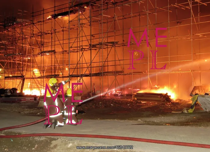 : Firefighters working at fire on building site : Firefighters working at fire on building site
