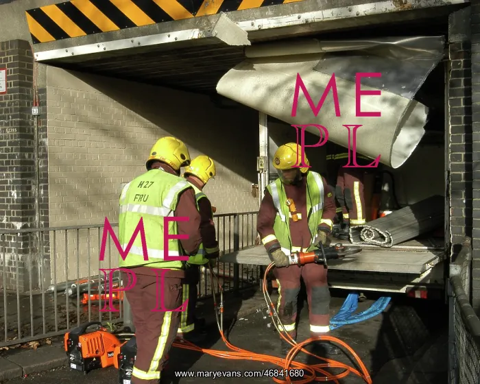  : Firefighters working to remove van trapped under bridge