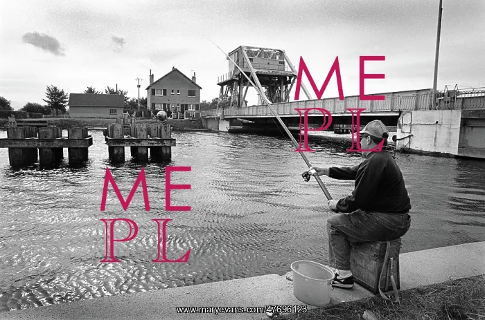 : A fisherman sits on the towpath of the Caen Canal : A fisherman sits on the towpath of the Caen Canal
